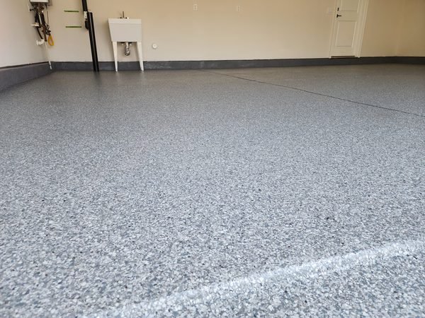 Finished garage with grey flake epoxy floor and crisp edge detail, Lake Norman NC