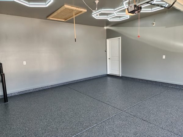 Modern 2-car garage with hex LED ceiling lights and dark grey flake epoxy floor, Mooresville NC
