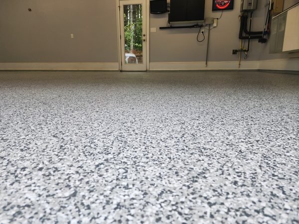 Finished garage with grey and white flake epoxy floor and glass back door, Mooresville NC