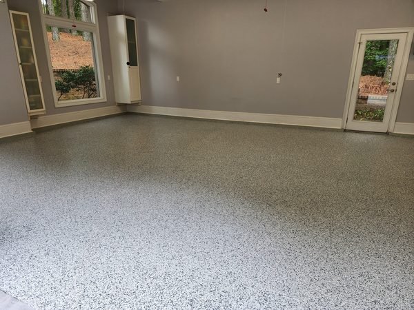Spacious finished garage with grey flake epoxy floor, large windows, and glass door, Lake Norman NC