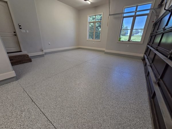 Bright finished garage with light grey flake epoxy floor and daylight windows, Mooresville NC